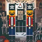 Halloween-themed door decorations with skeletons and pumpkins on a wooden door.