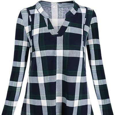 Plaid shirt with green, white, and navy pattern on a white background