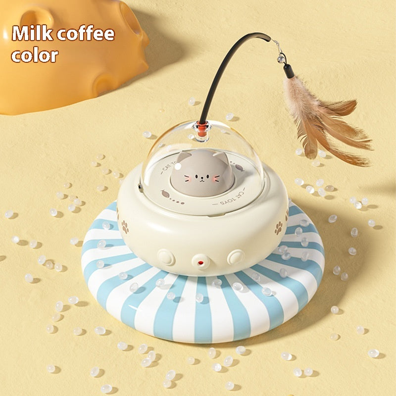 Cat-shaped toy with a transparent dome and feather on a yellow background