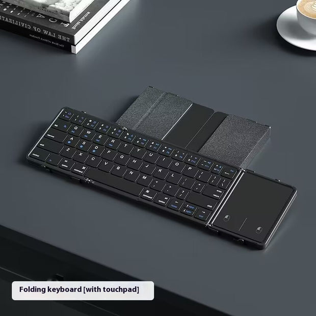 Folding keyboard with touchpad on a dark surface