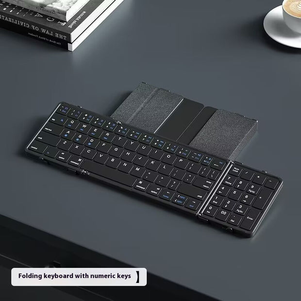 Folding keyboard with numeric keys on a dark surface