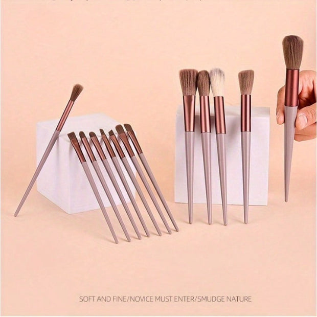 Set of makeup brushes with rose gold and silver handles on a pink background