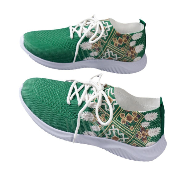 Green sneakers with white patterns on a white background