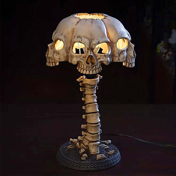 Skull-shaped lamp with glowing eyes on a dark background