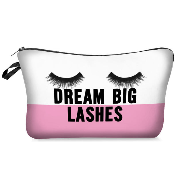 Makeup bag with eyelashes and 'Dream Big Lashes' text on a white background