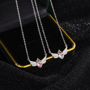 Two silver necklaces with heart and wing designs on a black background