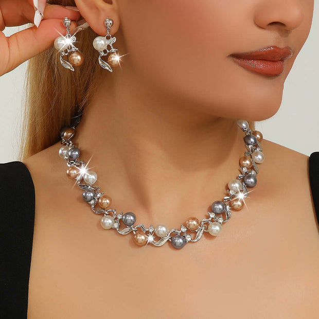 Pearl necklace and earrings on a model against a neutral background