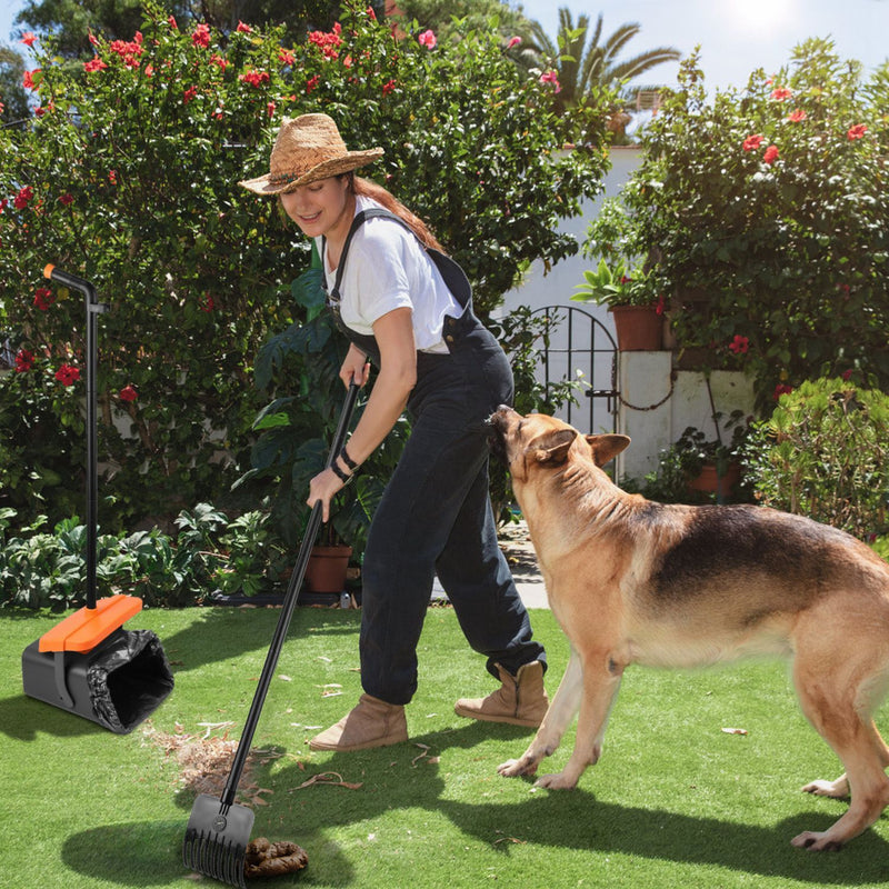 Person using a pet waste bag dispenser with a dog in a garden setting