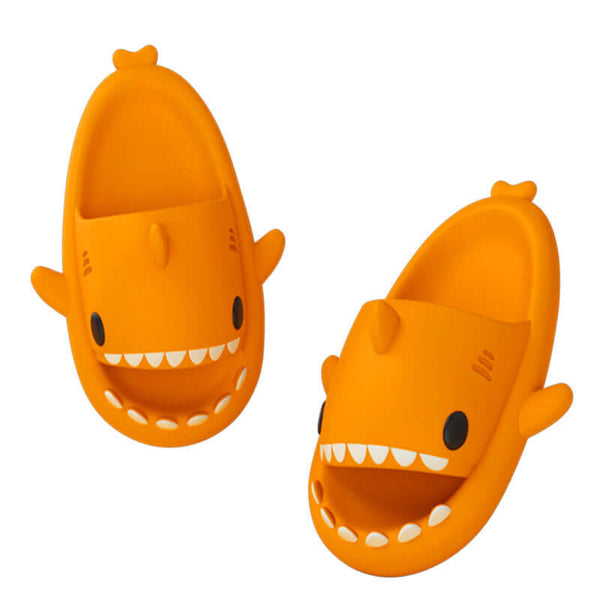 Fun cartoon shark slippers in bright orange for adults, featuring playful design and comfortable fit.