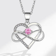 Heart-shaped silver necklace with pink gemstone and 'I love you' engraving on a white background