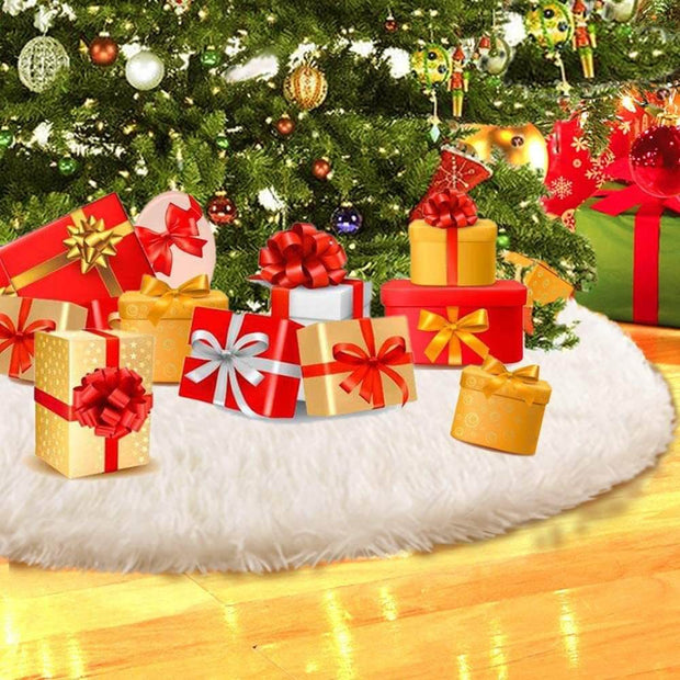 Decorative Christmas scene with presents under a tree on a white rug.