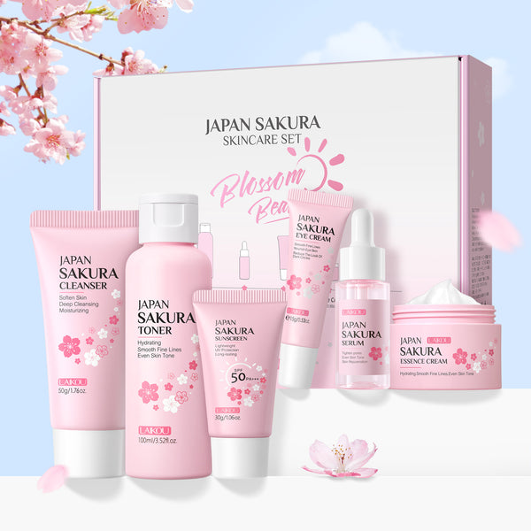 Japan Sakura skincare set with various products on a light blue background with cherry blossoms.