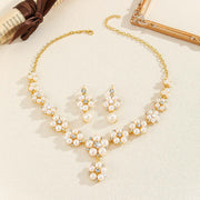 Pearl necklace and earrings set on a beige background