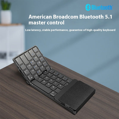 Foldable keyboard with Bluetooth 5.1 on a wooden surface, featuring American Broadcom branding.