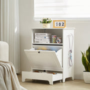White storage cabinet with a pull-out drawer in a room setting.