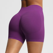 Purple athletic shorts worn by a person on a plain background