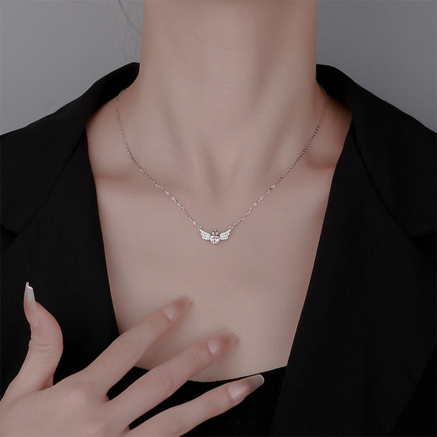 Necklace with a delicate pendant worn by a person against a neutral background