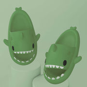 Fun green cartoon shark slippers for adults, featuring a cute design and comfortable fit for indoor and outdoor use.
