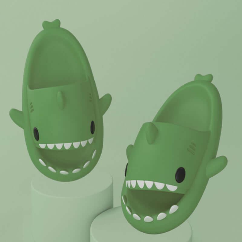 Fun green cartoon shark slippers for adults, featuring a cute design and comfortable fit for indoor and outdoor use.
