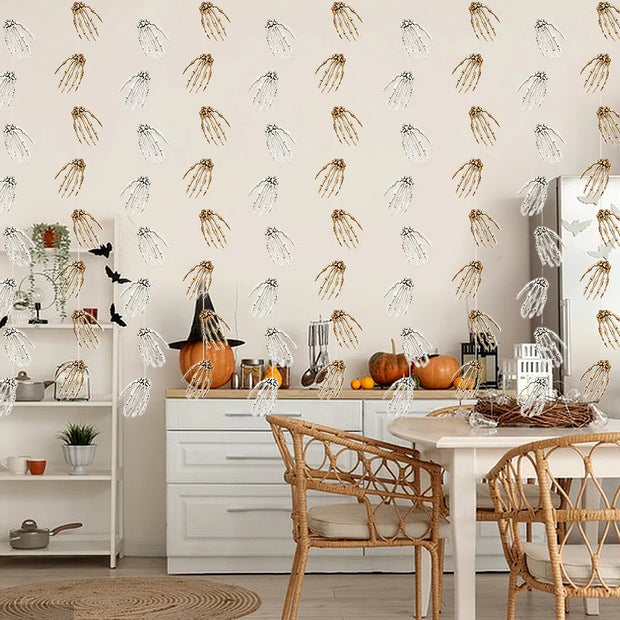 Dining room with Halloween decorations, including pumpkins and black hats, against a wallpapered wall.