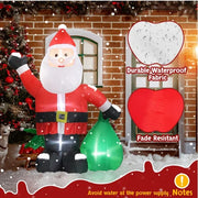 Inflatable Santa Claus decoration with a green sack, standing in front of a brick wall with a Christmas tree and dog.