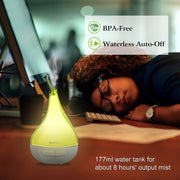 Person lying on a desk with a yellow and white diffuser, text indicating BPA-free and waterless auto-off features.